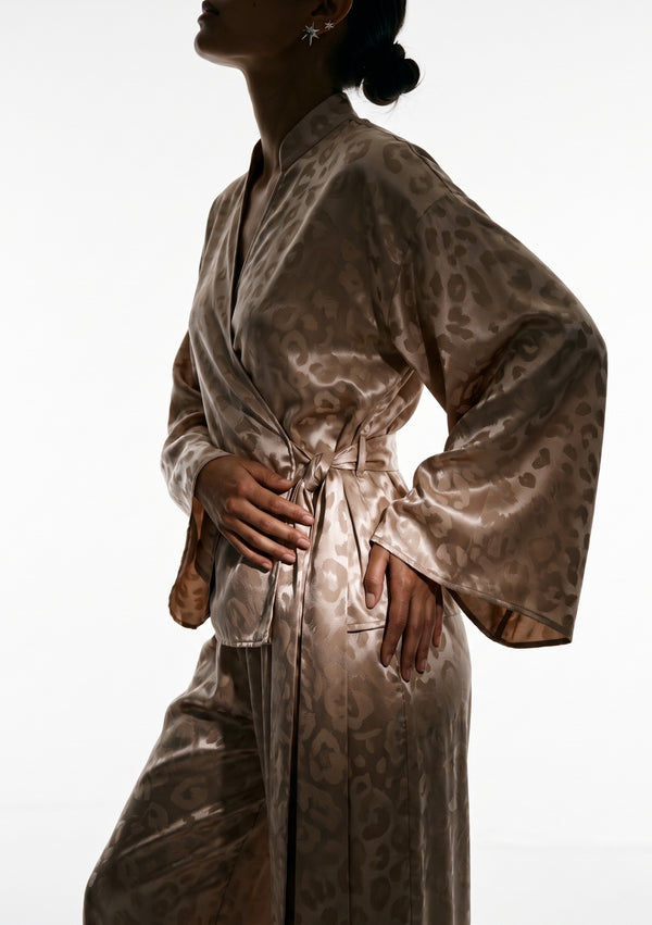 Close view of the Feline wrap shirt, stand collar splitting into a V and the sash knotted at the side waist