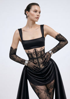 Model wears the black satin Baccara Top with the sheer lace Baccara corset skirt and lace gloves