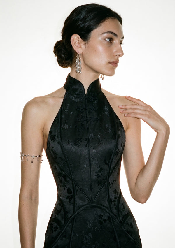 Front bodice detail of the Vespera dress showing the mandarin collar, frog clasps and sakura jacquard