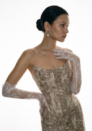 White floral lace opera gloves worn above the elbow with the Lucentia toile corset dress, one hand at the shoulder and one at the waist