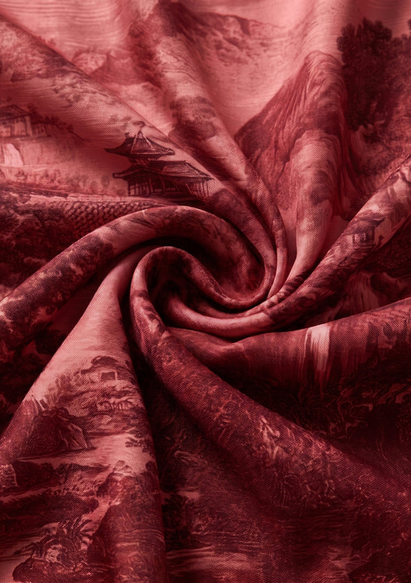 Crimson Dusk silk scarf swirled into a spiral to show its fluid drape and deep wine red luster