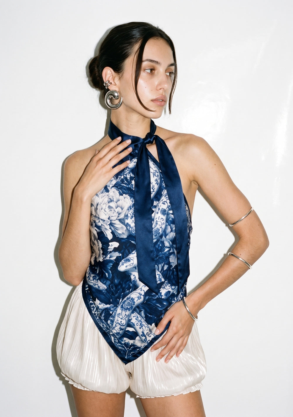 Mirage Peony top worn untucked, the pointed hem hanging loose and one navy tie falling down the centre front