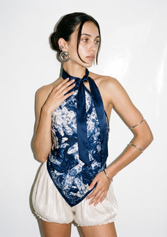 Mirage Peony top worn untucked, the pointed hem hanging loose and one navy tie falling down the centre front