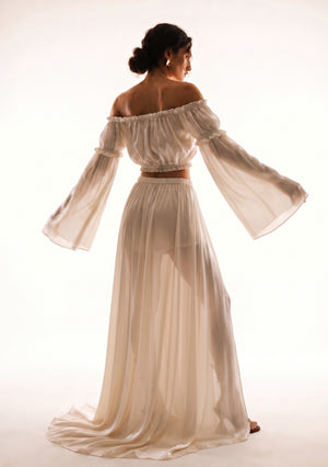 Sirocco cream satin-chiffon maxi skirt back view worn on-model with the crop top, side profile pose