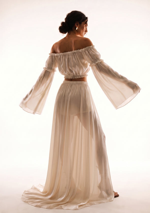Sirocco cream satin-chiffon maxi skirt back view worn on-model with the crop top, side profile pose