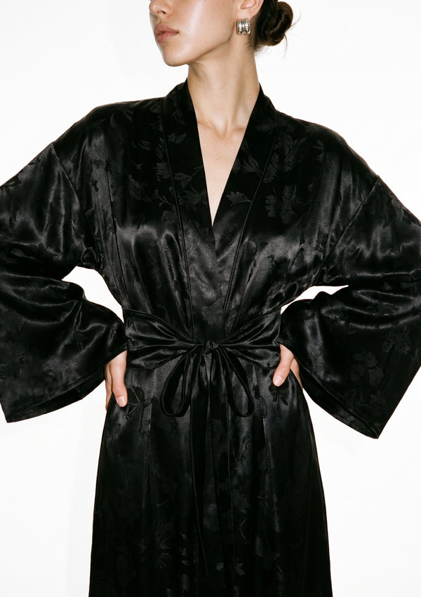 Detail of the Tenebrae robe, deep V shawl collar over the wide belt tied in a bow, with the wide bell sleeves falling either side