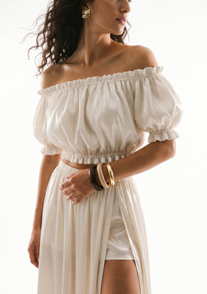 Sirocco cream satin-chiffon maxi skirt front view worn on-model showing the high slit and built-in short base