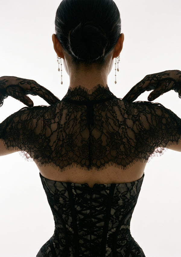 Eclipse Cape black lace capelet back view with matching lace gloves, hands raised showing scalloped hem detail