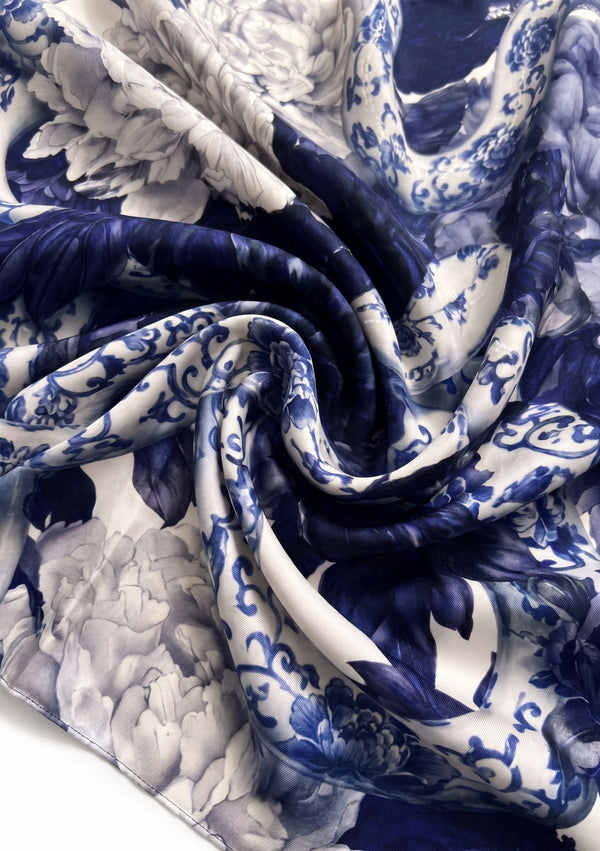 Mirage Peony Scarf swirled to show the fluid drape and luminous finish of the printed blue and white silk
