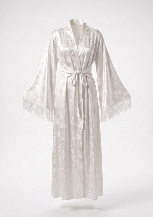 Moonveil robe shown on an invisible mannequin, sleeves spread to show the fringed cuffs and the tonal woven floral on ivory