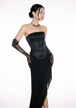 Spell Corset in black satin jacquard, strapless with a dipped front hem, worn with the Spell Skirt and black lace opera gloves.