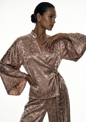 Detail of the Feline shirt, wide bell sleeve raised to show the tonal leopard woven into the beige satin