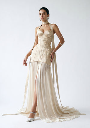 Nacre dress styled as a full-length look, corset bodice with shell cups over a flowing champagne chiffon maxi skirt with thigh-high slit and train