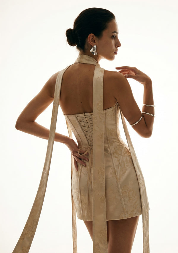 Nacre dress back three quarter view with corset lace-up and shoulder ribbons