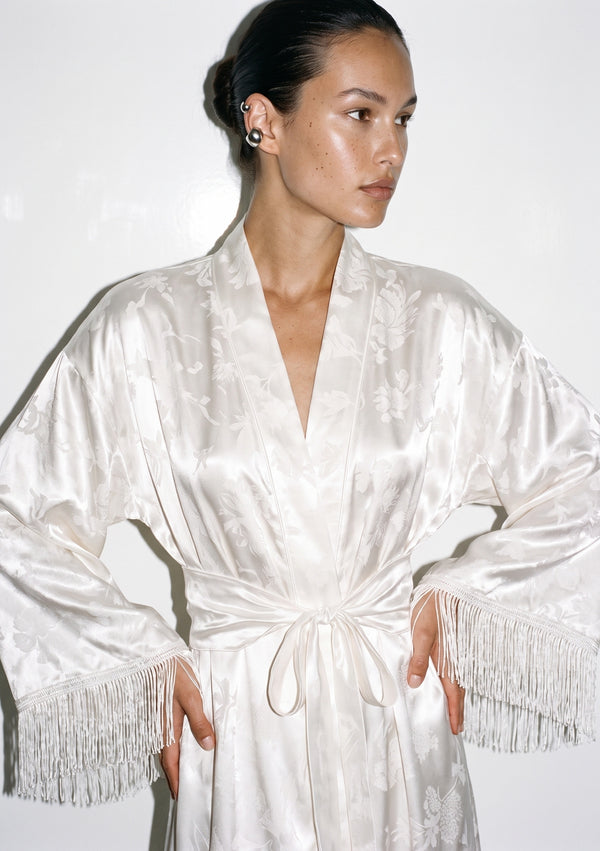 Upper body view of the Moonveil robe, the collar meeting at the chest above the sash, fringe visible at both cuffs