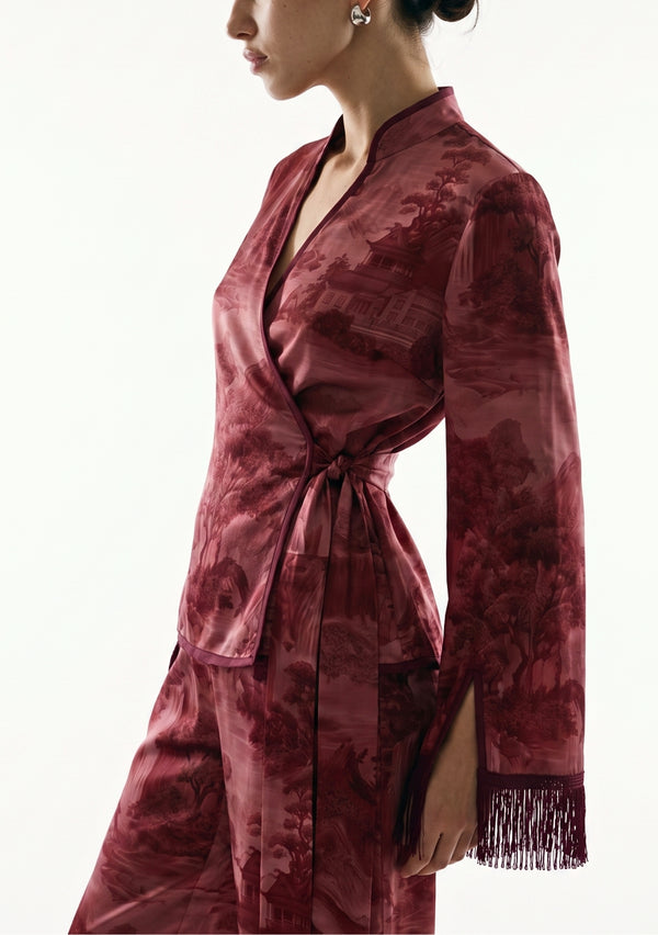 Crimson Dusk Set detail, satin sash knotted at the side waist of the burgundy wrap top with the wrist slit and silk fringe cuff in view