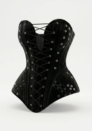 La Musa Midnight Corset product shot: black velvet strapless overbust corset with a sweetheart neckline, silver-eyelet front lace-up and grommet-trimmed hip flaps