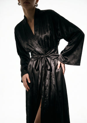 Close view of the Tenebrae robe bodice, elongated shawl collar and the wide belt knotted with long trailing ties
