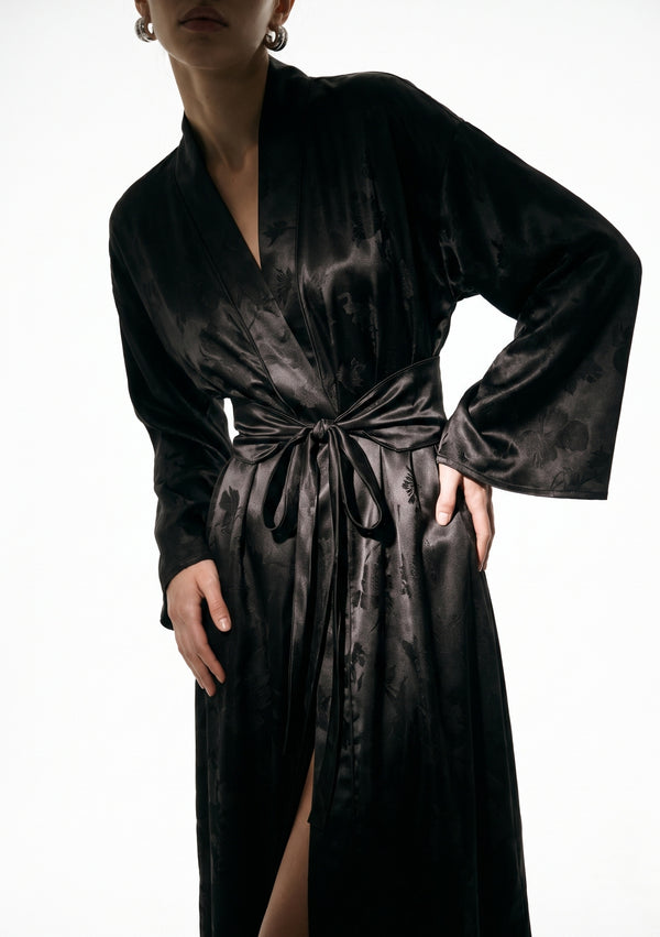 Close view of the Tenebrae robe bodice, elongated shawl collar and the wide belt knotted with long trailing ties