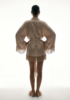 Back view of the Feline robe, belt fastened behind and fringe running along the hem and both sleeve cuffs