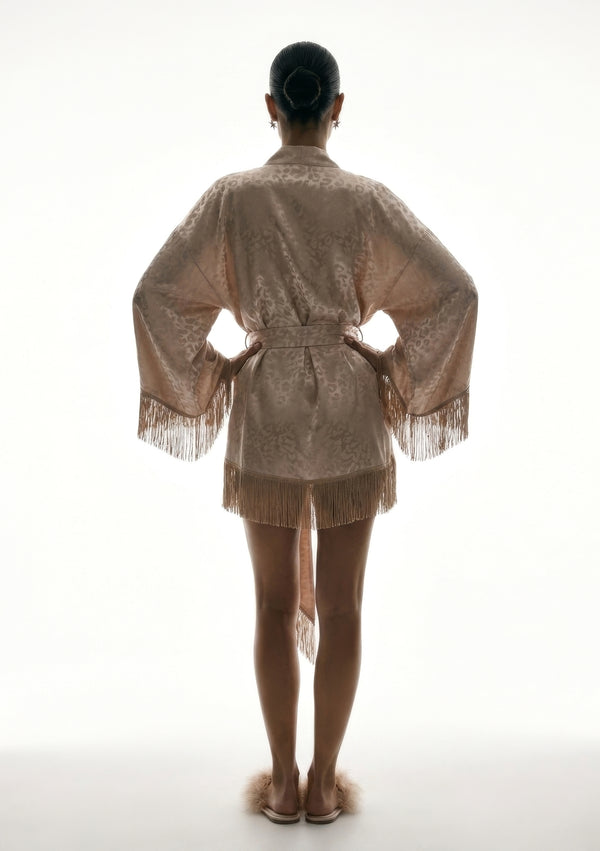 Back view of the Feline robe, belt fastened behind and fringe running along the hem and both sleeve cuffs