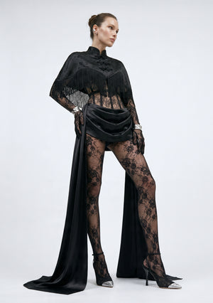 La Musa Baccara fringe capelet styled over the Baccara lace corset and draped satin skirt with lace tights, full-length view