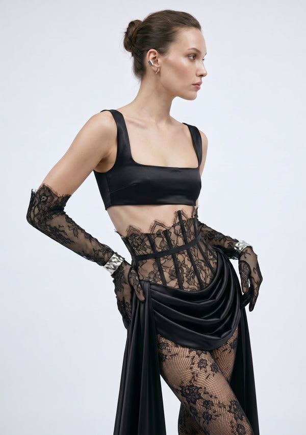 Side view of the black satin Baccara skirt with draped front over the lace corset waist
