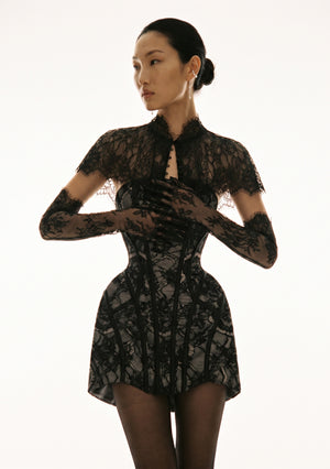 Eclipse Dress front view on-model, hands raised near face wearing black lace gloves, strapless corset bodice with black lace over grey satin