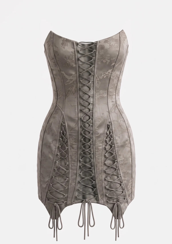 Lucentia corset mini dress on an invisible mannequin, showing the three laced panels, curved boned seams and the tab hem with long ties