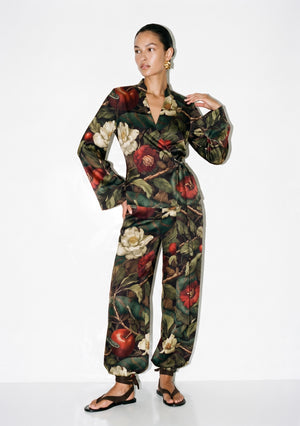 Front view of the Eden silk set, wrap top knotted at the side waist above wide trousers gathered into elasticated cuffs at the ankle