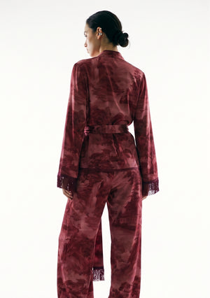 Crimson Dusk Set, back view on model showing the landscape print across the top, the sash tied at the back waist and the fringed sleeve cuffs