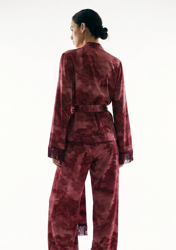 Crimson Dusk Set, back view on model showing the landscape print across the top, the sash tied at the back waist and the fringed sleeve cuffs