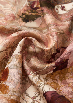 Close view of the Nimue silk scarf swirled to show the high-shine silk and the fine ink outlines of the floral artwork