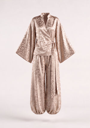 Feline set shown on an invisible mannequin, wrap shirt with wide bell sleeves above the matching cuffed trousers