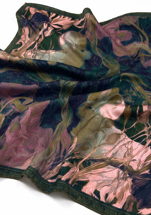 Draped Selene silk scarf showing the two white hares, the lilac irises and the tonal green border along the edge
